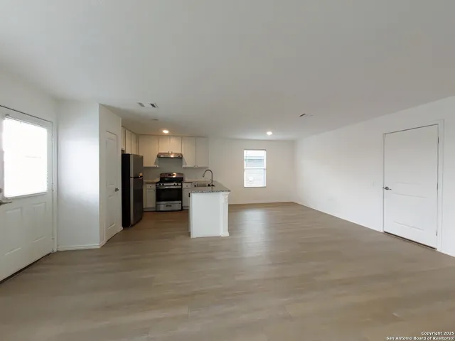 a view of a kitchen with a sink and a refrigerator