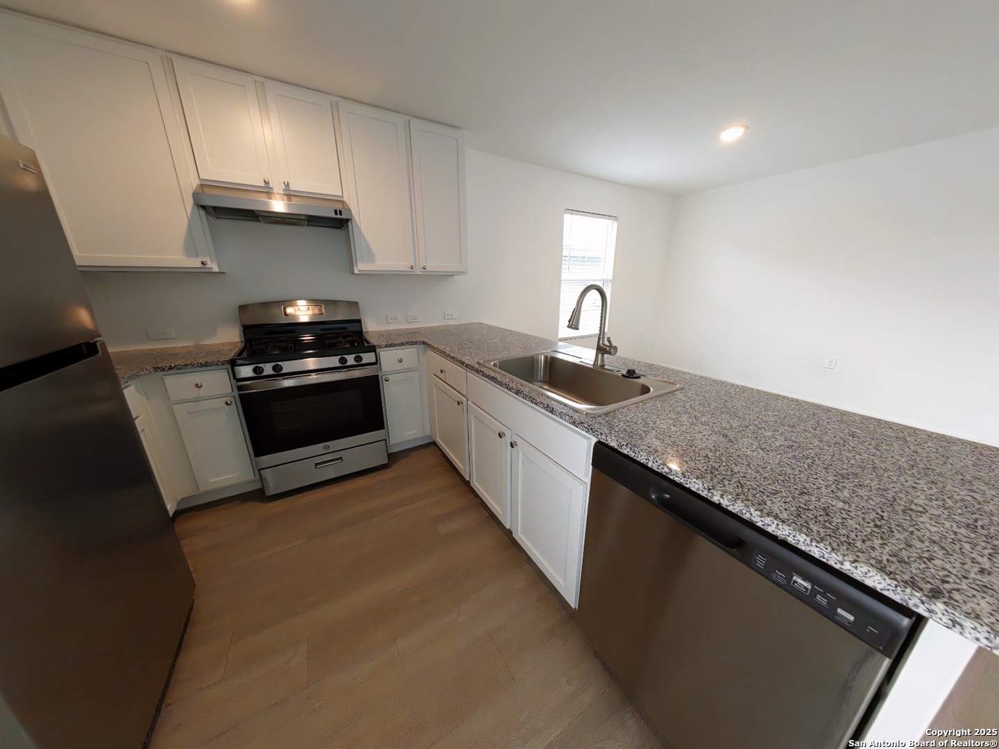 12039 Still Pass San Antonio, TX 78221 - Photo 6 of 19 a kitchen with granite countertop a sink dishwasher stove and cabinets