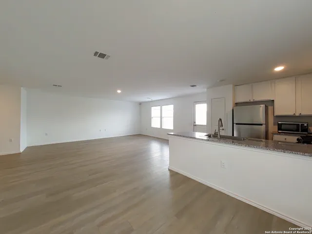 a view of a kitchen with a sink and a stove top oven