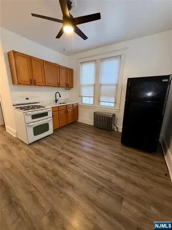 a kitchen with stainless steel appliances a stove a microwave and white cabinets