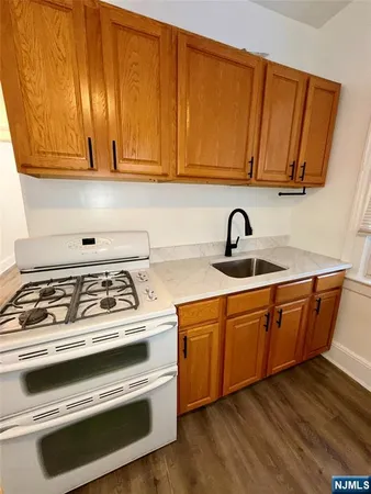 a kitchen with wooden cabinets and a stove top oven