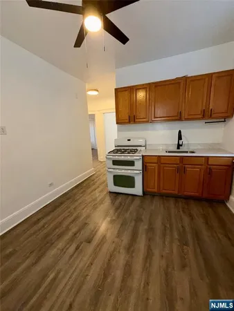 a view of kitchen with wooden floor and electronic appliances