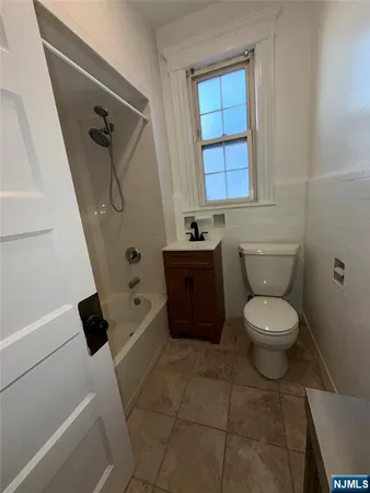 a bathroom with a toilet a sink and a window
