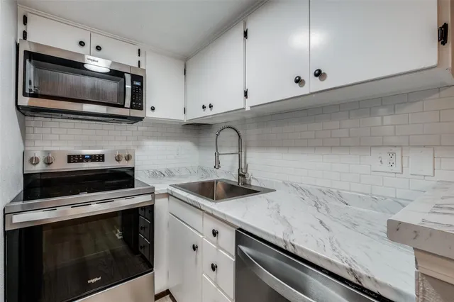 a kitchen with stainless steel appliances a refrigerator stove and microwave