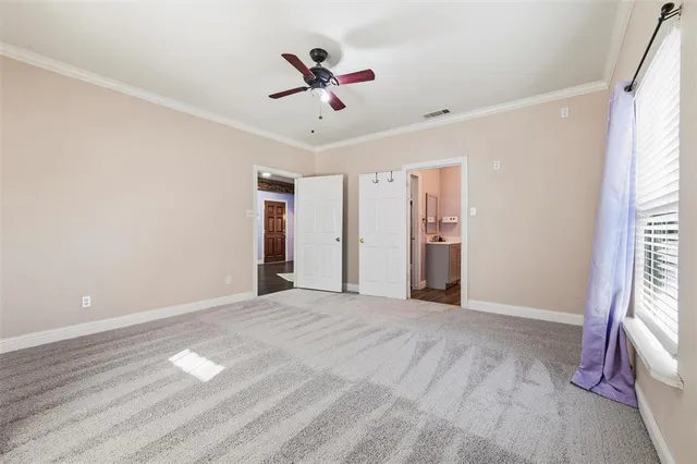 a bedroom with a large bed couch and a window