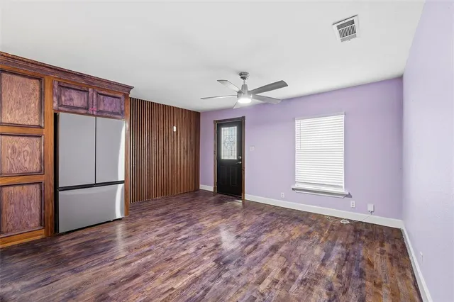 a view of a kitchen with wooden floor and a ceiling fan