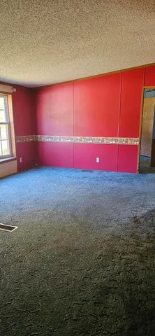 a view of empty room with red carpet