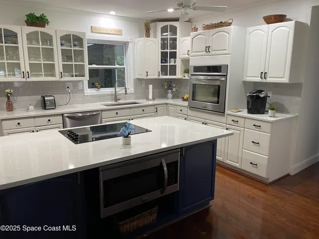a kitchen with stainless steel appliances a stove sink and cabinets