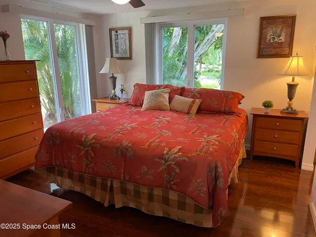 a large bed sitting in a bedroom next to a window