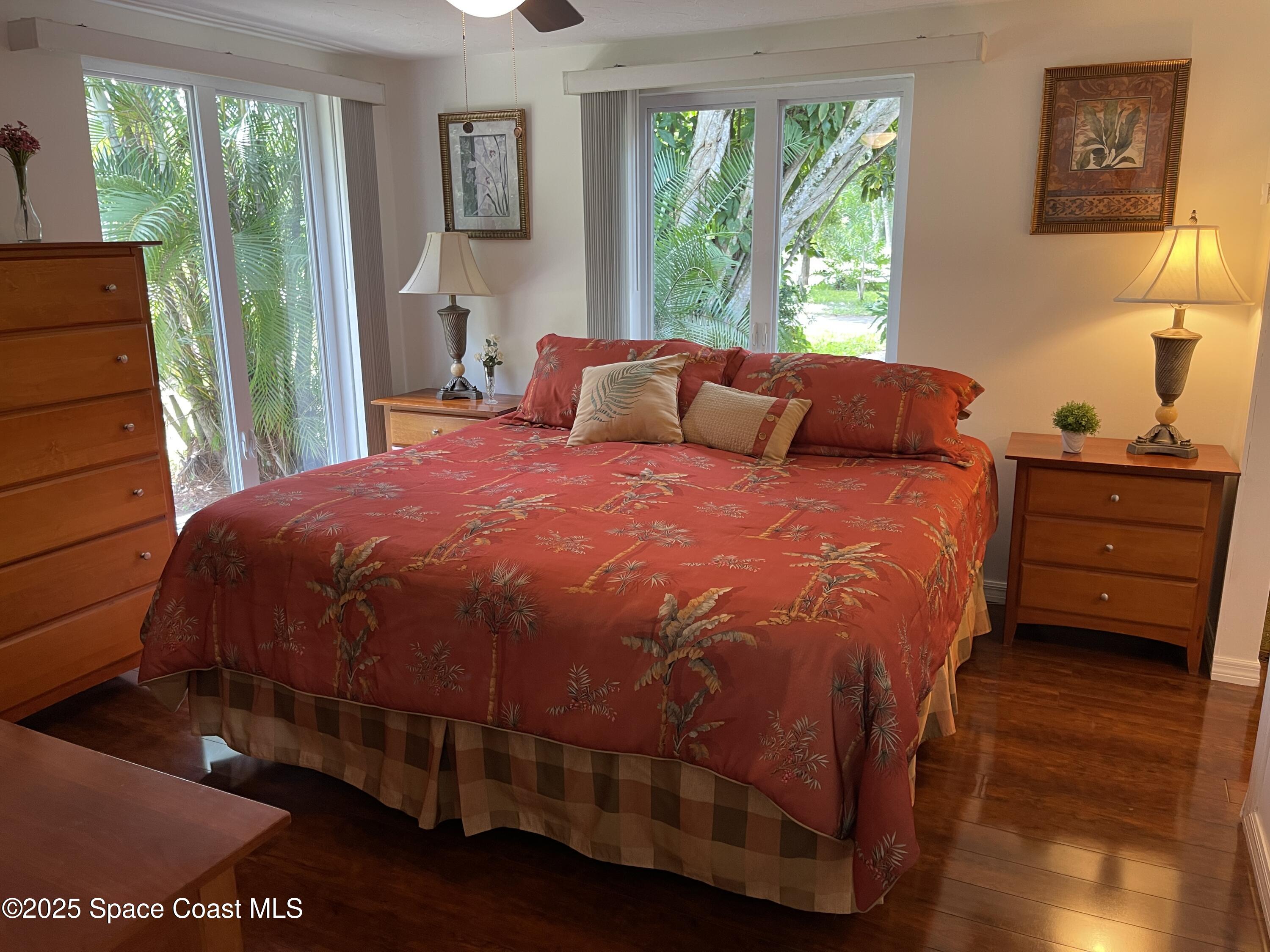 6910 Sheridan Road Melbourne, FL 32904 - Photo 14 of 38 a large bed sitting in a bedroom next to a window