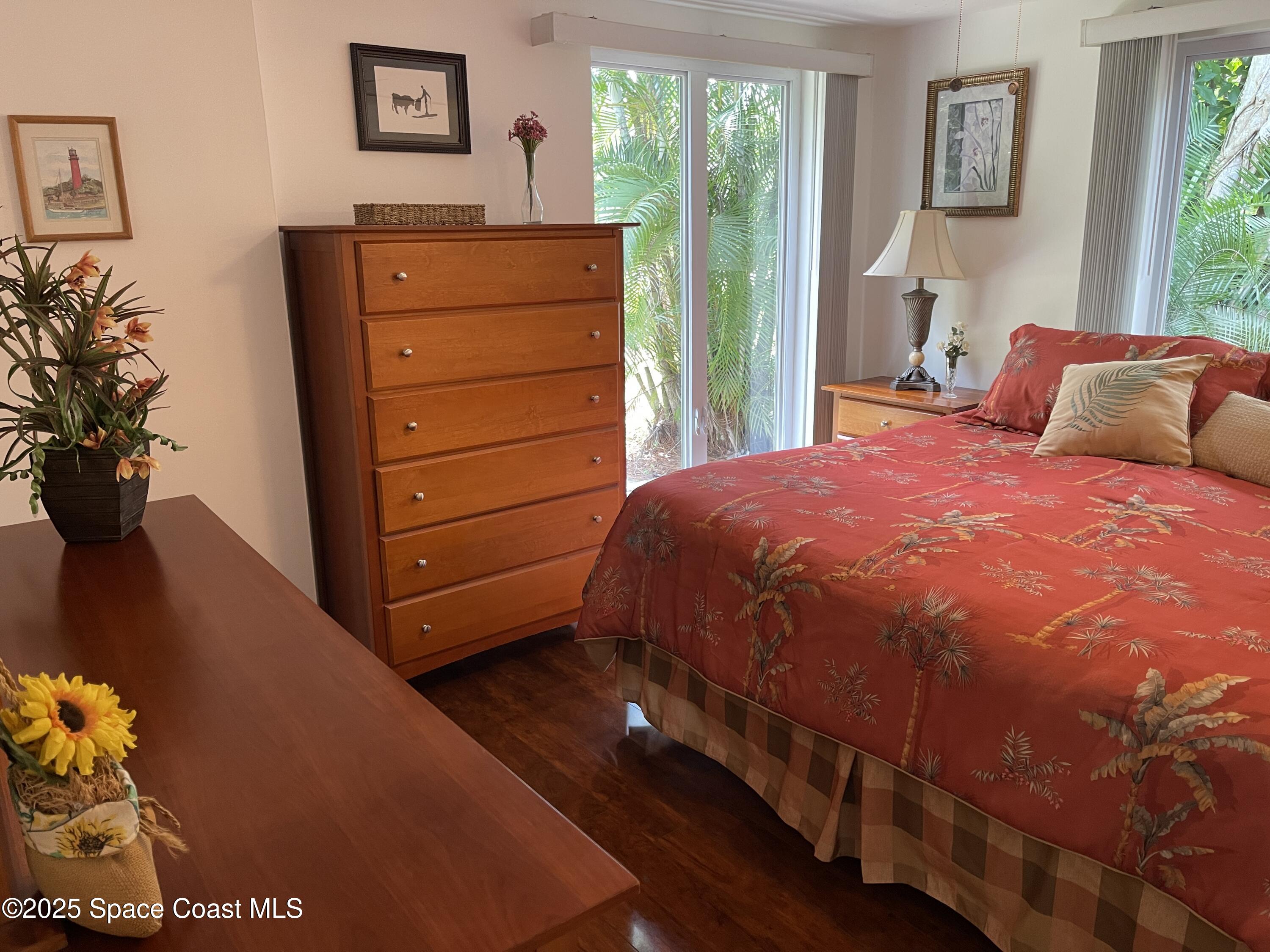 6910 Sheridan Road Melbourne, FL 32904 - Photo 15 of 38 a bedroom with a bed and a dresser