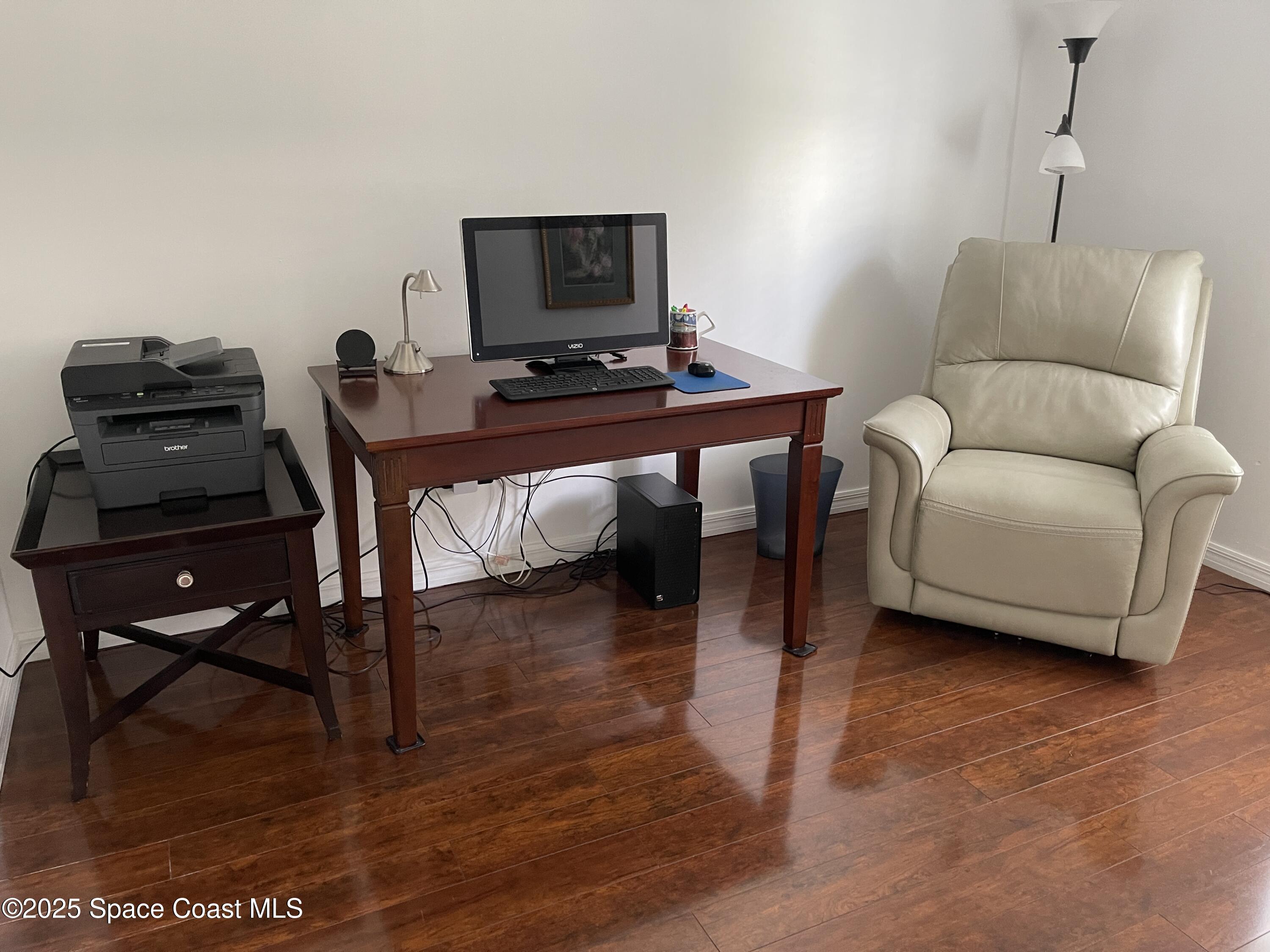 6910 Sheridan Road Melbourne, FL 32904 - Photo 20 of 38 a living room with furniture and a flat screen tv