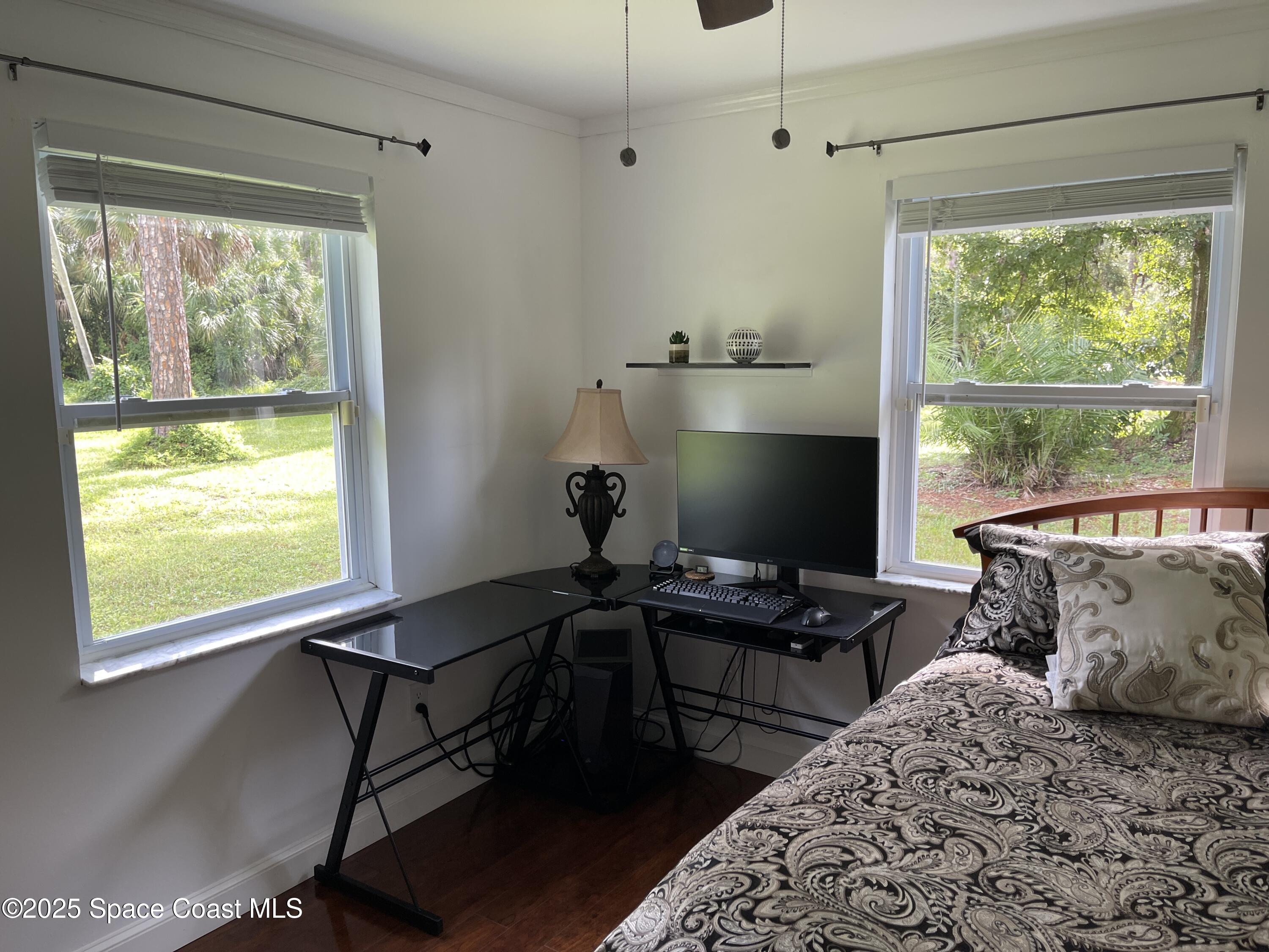 6910 Sheridan Road Melbourne, FL 32904 - Photo 22 of 38 a bedroom with a bed and a window