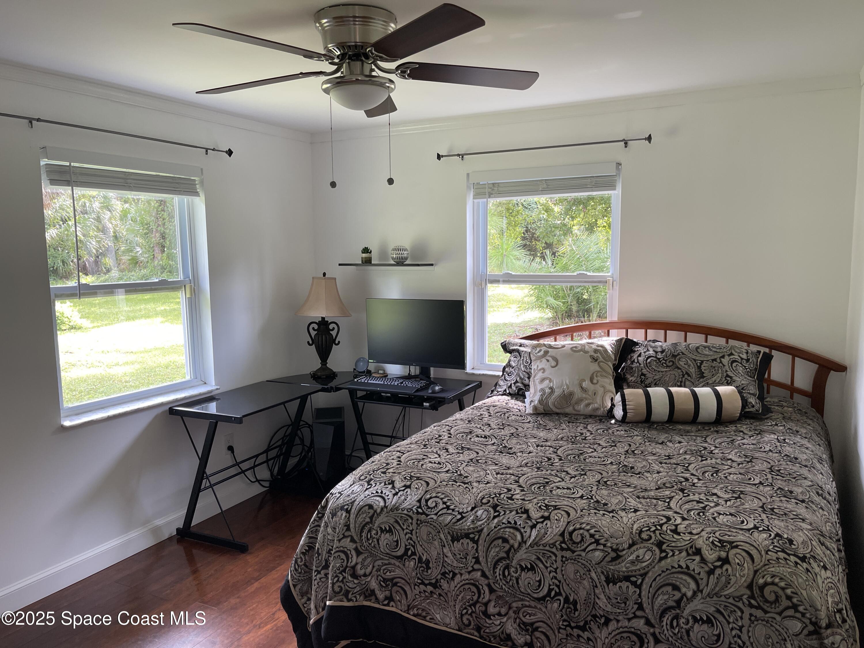 6910 Sheridan Road Melbourne, FL 32904 - Photo 23 of 38 a bedroom with a large bed and a window