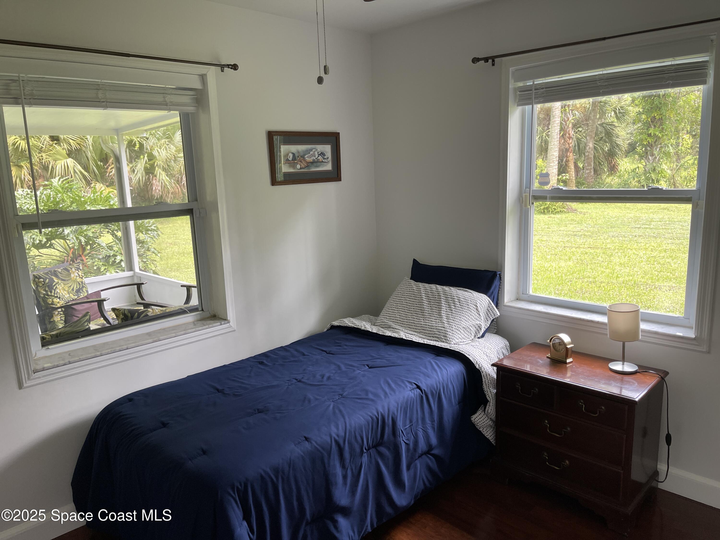 6910 Sheridan Road Melbourne, FL 32904 - Photo 24 of 38 a bedroom with a bed and a window