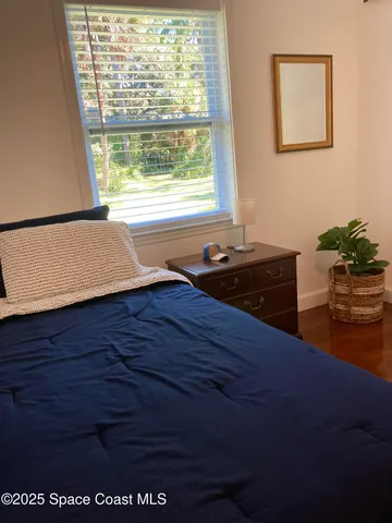 a room with a window and wooden floor