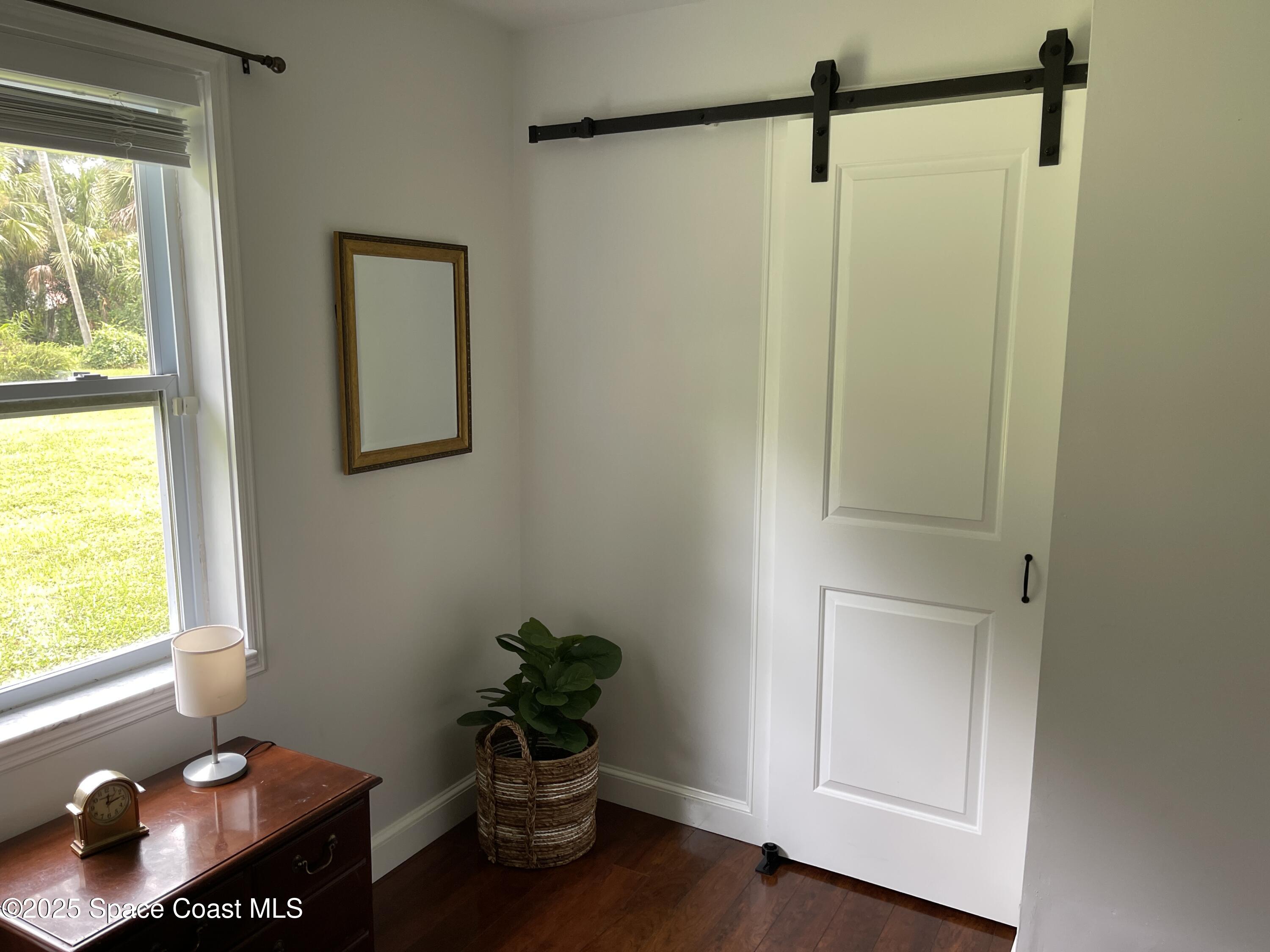 6910 Sheridan Road Melbourne, FL 32904 - Photo 26 of 38 a room with a window and wooden floor