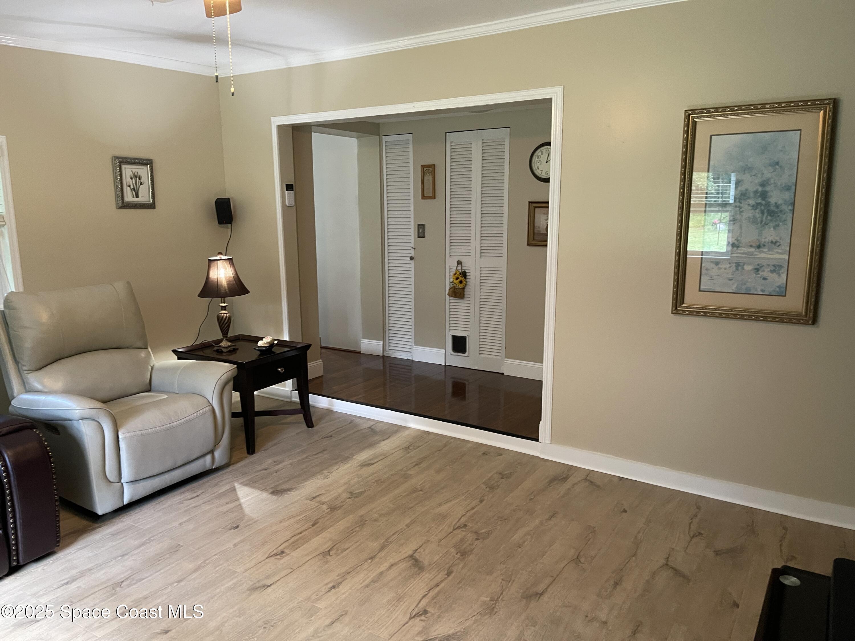 6910 Sheridan Road Melbourne, FL 32904 - Photo 30 of 38 a living room with furniture and a window
