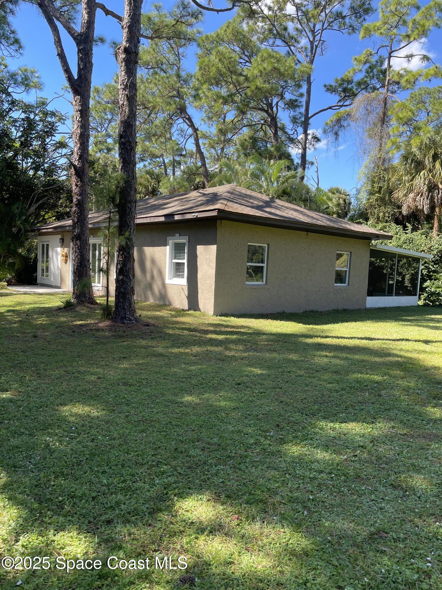 6910 Sheridan Road Melbourne, FL 32904 - Photo 33 of 38 a view of outdoor space yard and front view of a house
