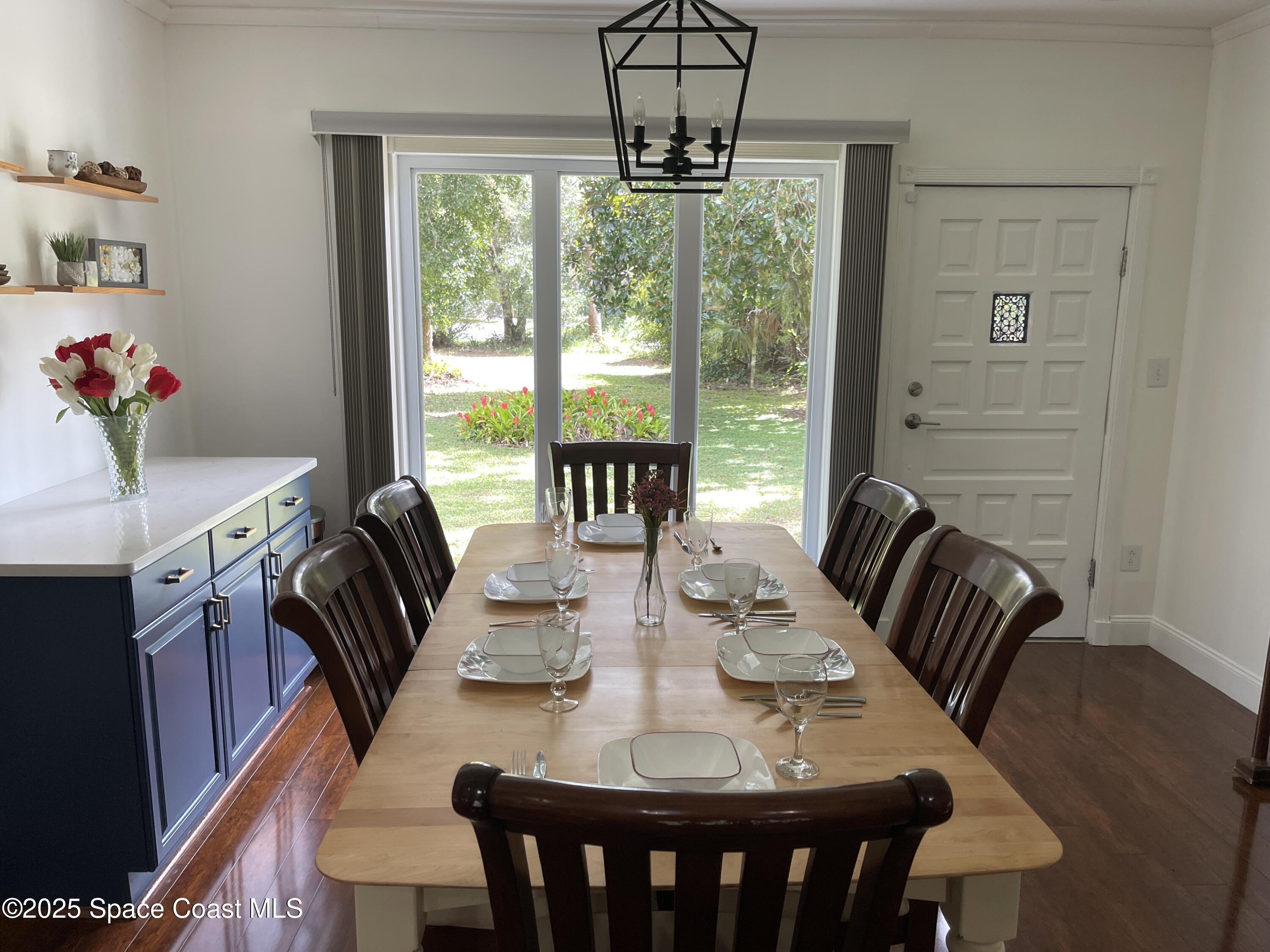 6910 Sheridan Road Melbourne, FL 32904 - Photo 9 of 38 a view of a dining room with furniture window and outside view