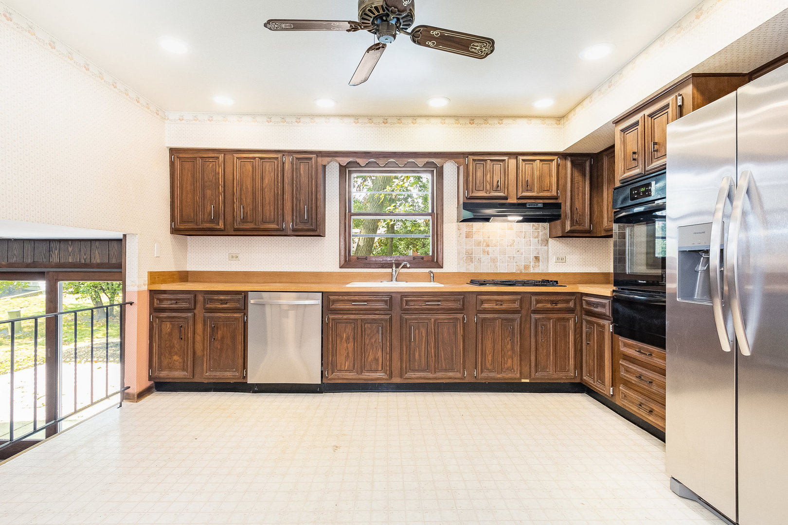 17010 Gaynelle Road Tinley Park, IL 60477 - Photo 4 of 19 a kitchen with stainless steel appliances a refrigerator and a stove top oven