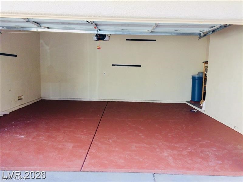 8897 Houston Ridge Avenue Las Vegas, NV 89178 - Photo 9 of 12 A spacious garage with a durable, easy-to-maintain floor, perfect for vehicles or extra storage.