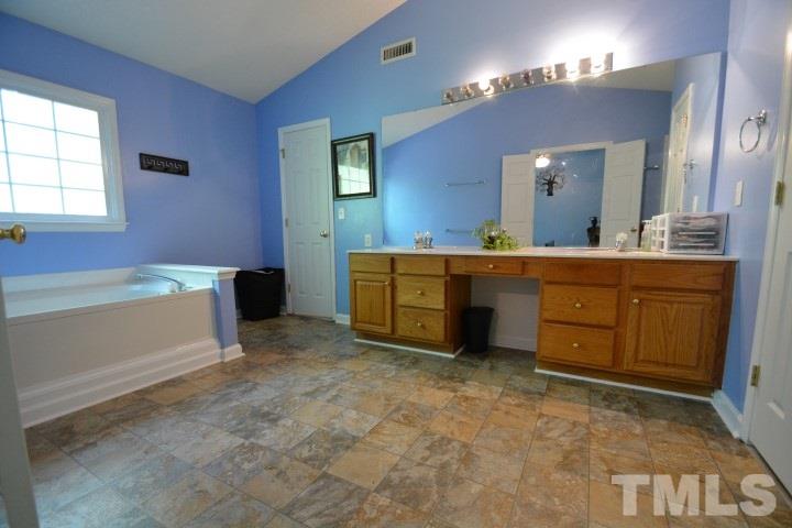 6208 Brielson Place Raleigh, NC 27616 - Photo 11 of 18 a spacious bathroom with a sink and a mirror