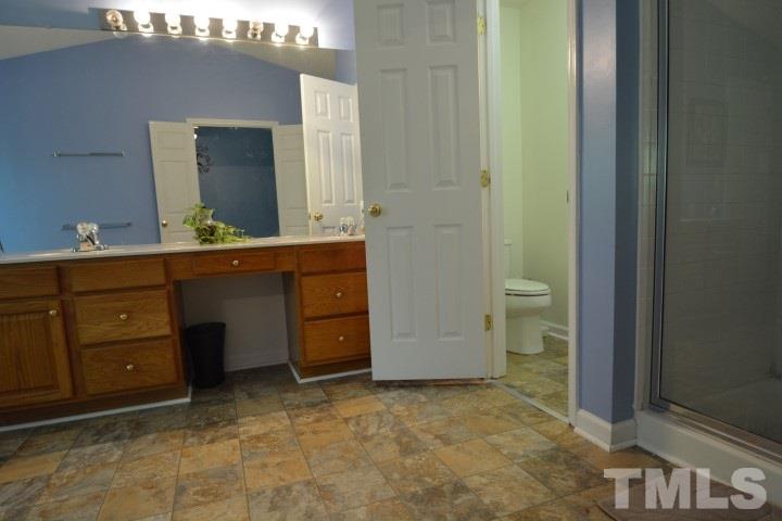6208 Brielson Place Raleigh, NC 27616 - Photo 12 of 18 a bathroom with a sink and a mirror