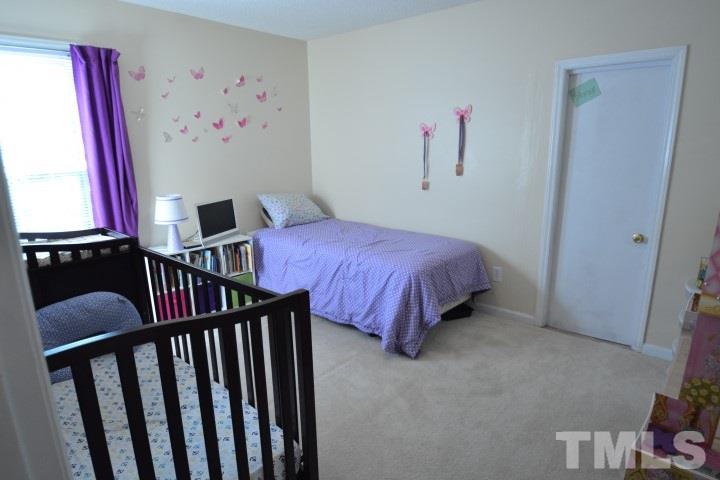 6208 Brielson Place Raleigh, NC 27616 - Photo 14 of 18 a bedroom with a bed and window