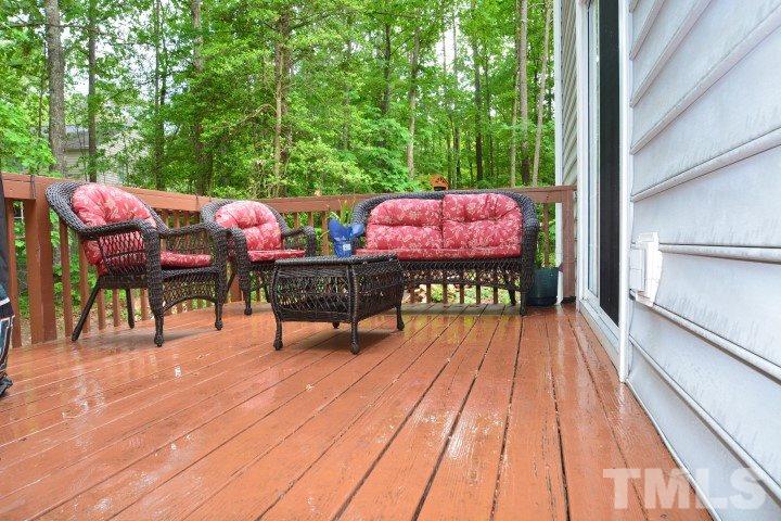 6208 Brielson Place Raleigh, NC 27616 - Photo 16 of 18 a view of a patio with table and chairs and wooden floor