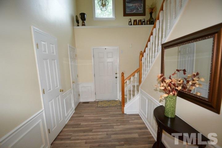 6208 Brielson Place Raleigh, NC 27616 - Photo 3 of 18 a view of a hallway with wooden floor and stairs