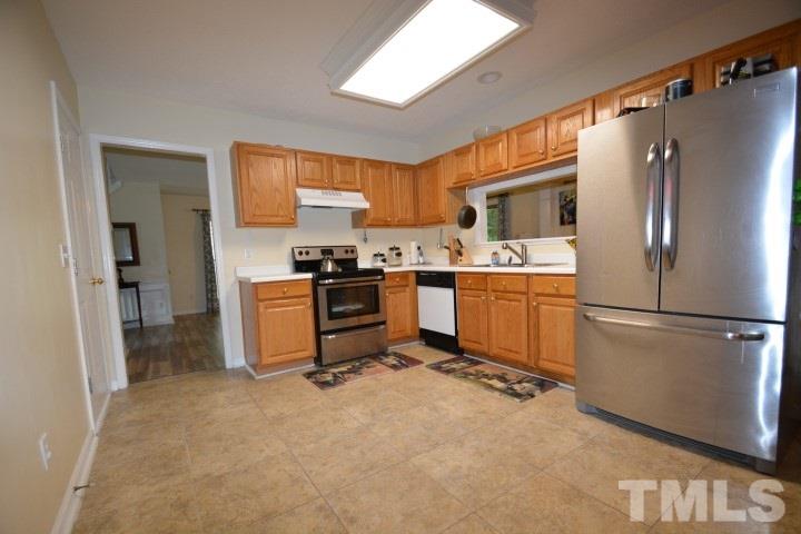 6208 Brielson Place Raleigh, NC 27616 - Photo 6 of 18 a kitchen with stainless steel appliances granite countertop a refrigerator stove a sink dishwasher and a refrigerator