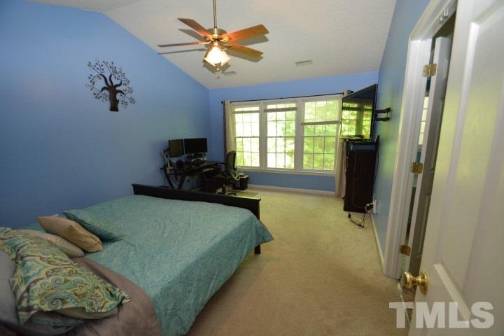 6208 Brielson Place Raleigh, NC 27616 - Photo 10 of 18 a bed sitting in a bedroom next to a window