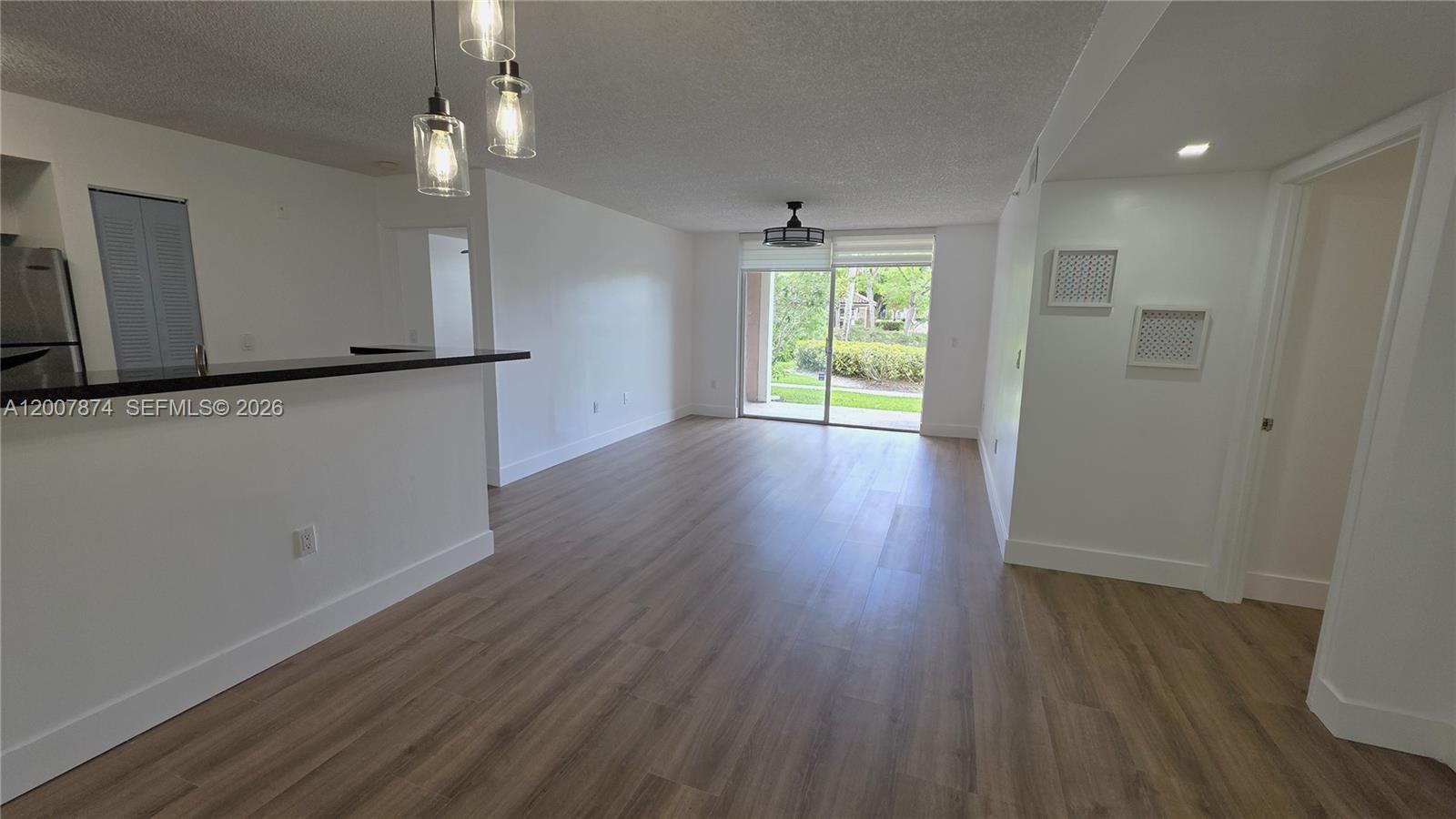12136 St.Andrews Place, Unit 108 Miramar, FL 33025 - Photo 1 of 43 a view of an empty room with wooden floor and a window