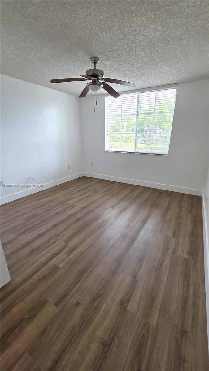 12136 St.Andrews Place, Unit 108 Miramar, FL 33025 - Photo 13 of 43 an empty room with wooden floor fan and windows