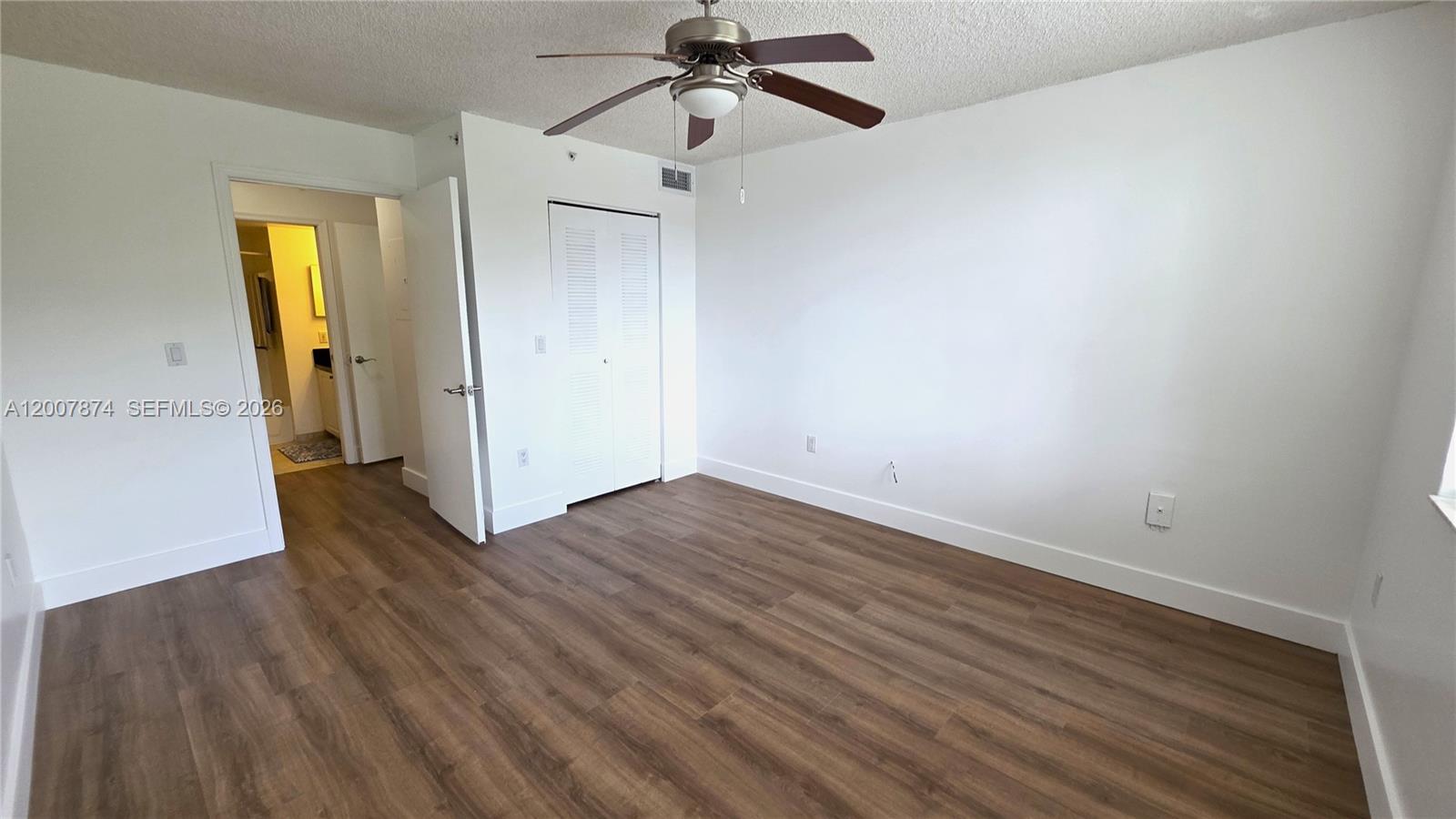 12136 St.Andrews Place, Unit 108 Miramar, FL 33025 - Photo 14 of 43 a view of empty room with wooden floor and ceiling fan