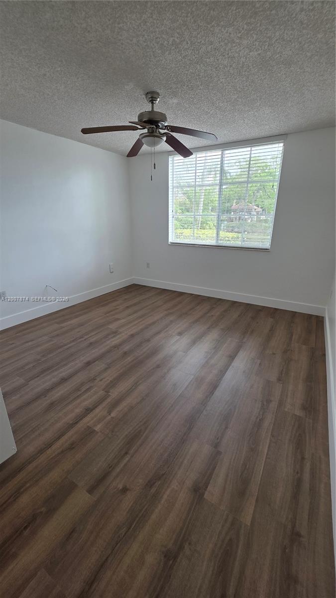 12136 St.Andrews Place, Unit 108 Miramar, FL 33025 - Photo 18 of 43 an empty room with wooden floor fan and windows