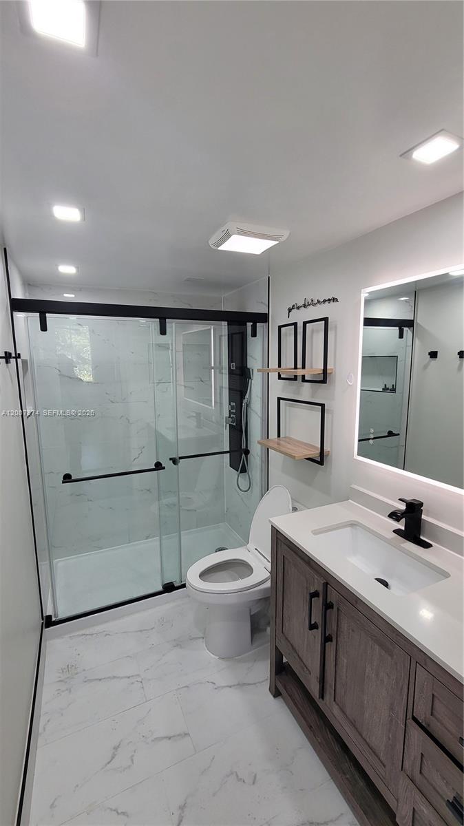12136 St.Andrews Place, Unit 108 Miramar, FL 33025 - Photo 21 of 43 a bathroom with a sink a toilet and shower