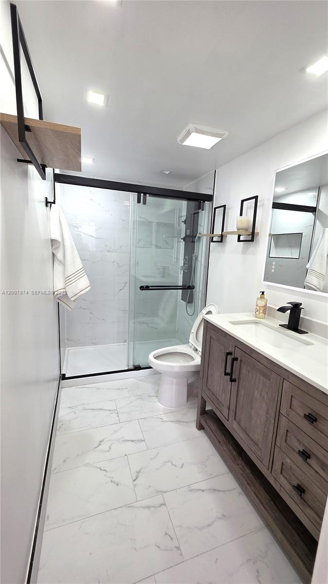 12136 St.Andrews Place, Unit 108 Miramar, FL 33025 - Photo 24 of 43 a spacious bathroom with a double vanity sink toilet and shower