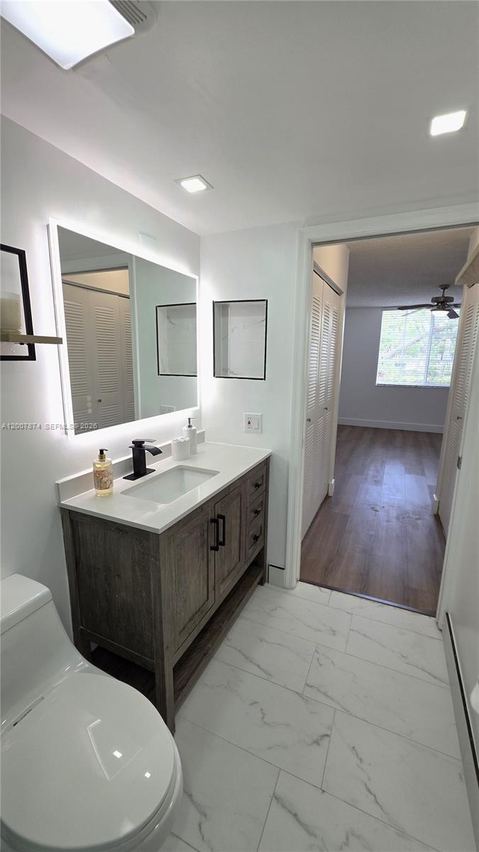 12136 St.Andrews Place, Unit 108 Miramar, FL 33025 - Photo 25 of 43 a bathroom with a sink mirror and vanity