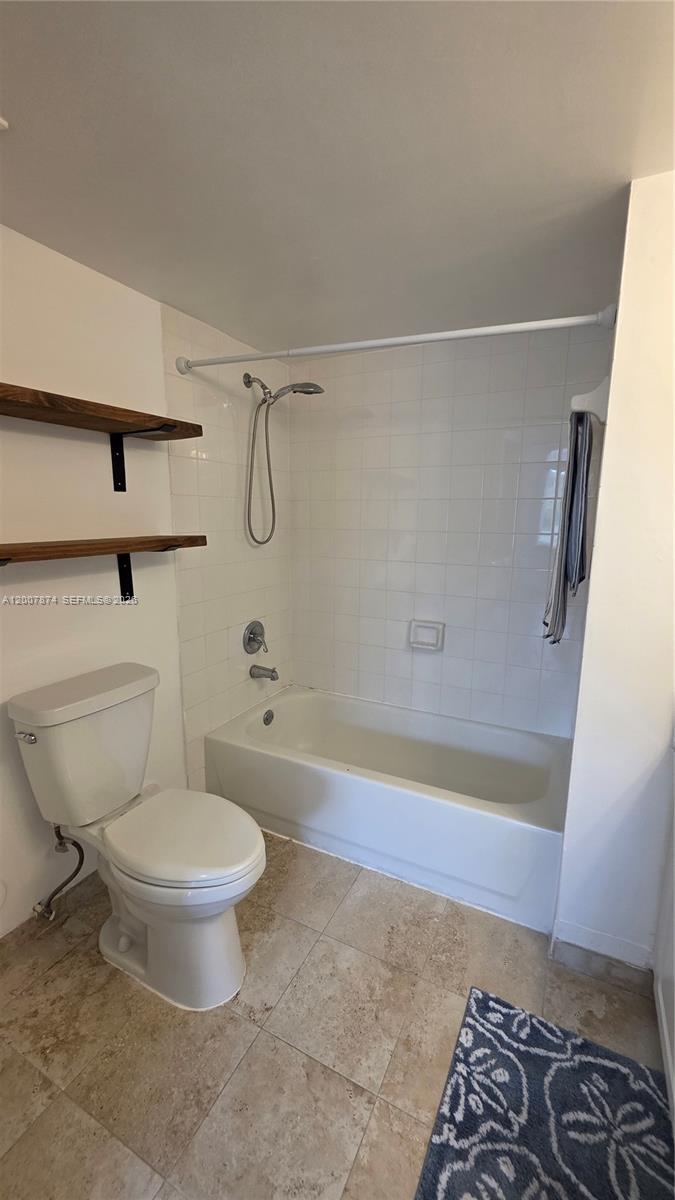 12136 St.Andrews Place, Unit 108 Miramar, FL 33025 - Photo 27 of 43 a bathroom with a toilet and a shower
