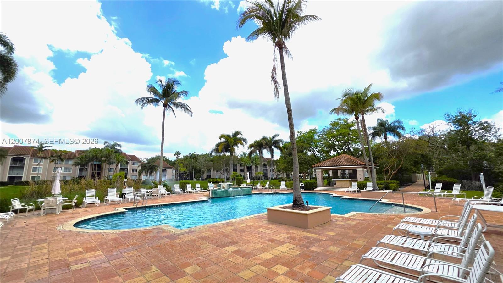 12136 St.Andrews Place, Unit 108 Miramar, FL 33025 - Photo 29 of 43 a view of a house with swimming pool and a garden