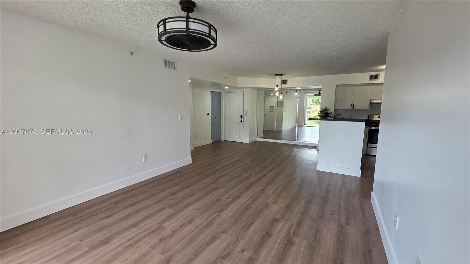 12136 St.Andrews Place, Unit 108 Miramar, FL 33025 - Photo 3 of 43 a view of a room with wooden floor and ceiling fan