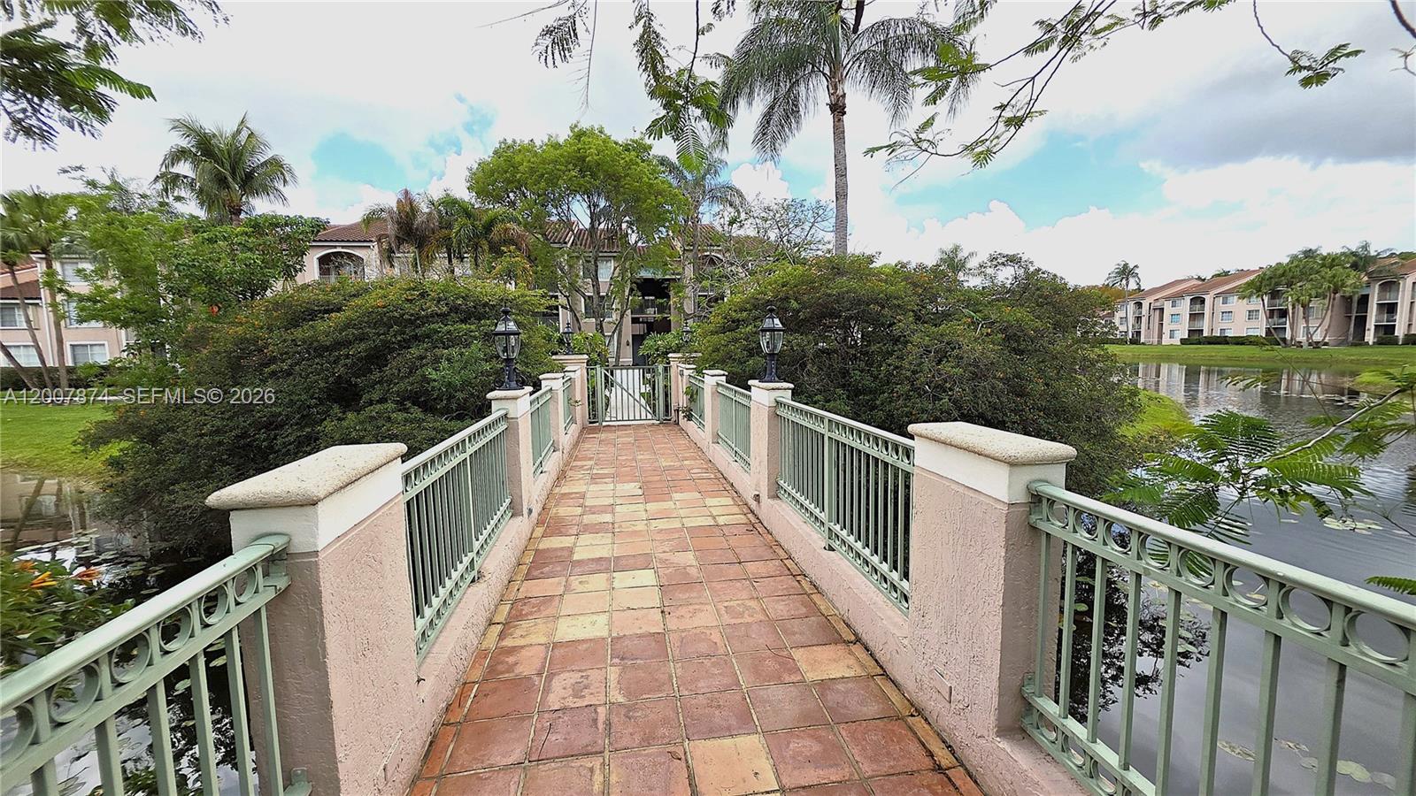 12136 St.Andrews Place, Unit 108 Miramar, FL 33025 - Photo 35 of 43 a view of a pathway and a wooden bridge