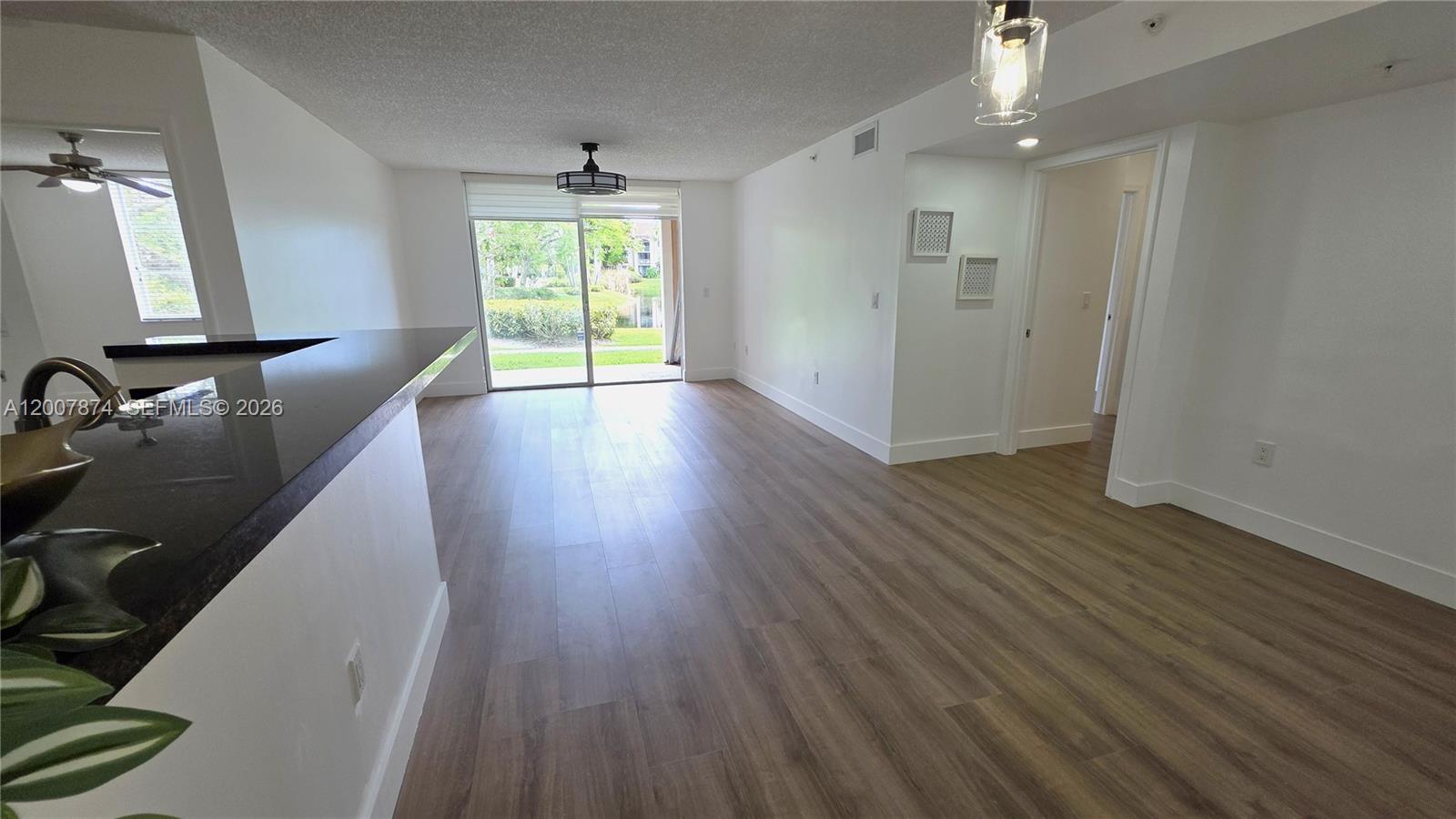 12136 St.Andrews Place, Unit 108 Miramar, FL 33025 - Photo 4 of 43 wooden floor in an empty room with a window