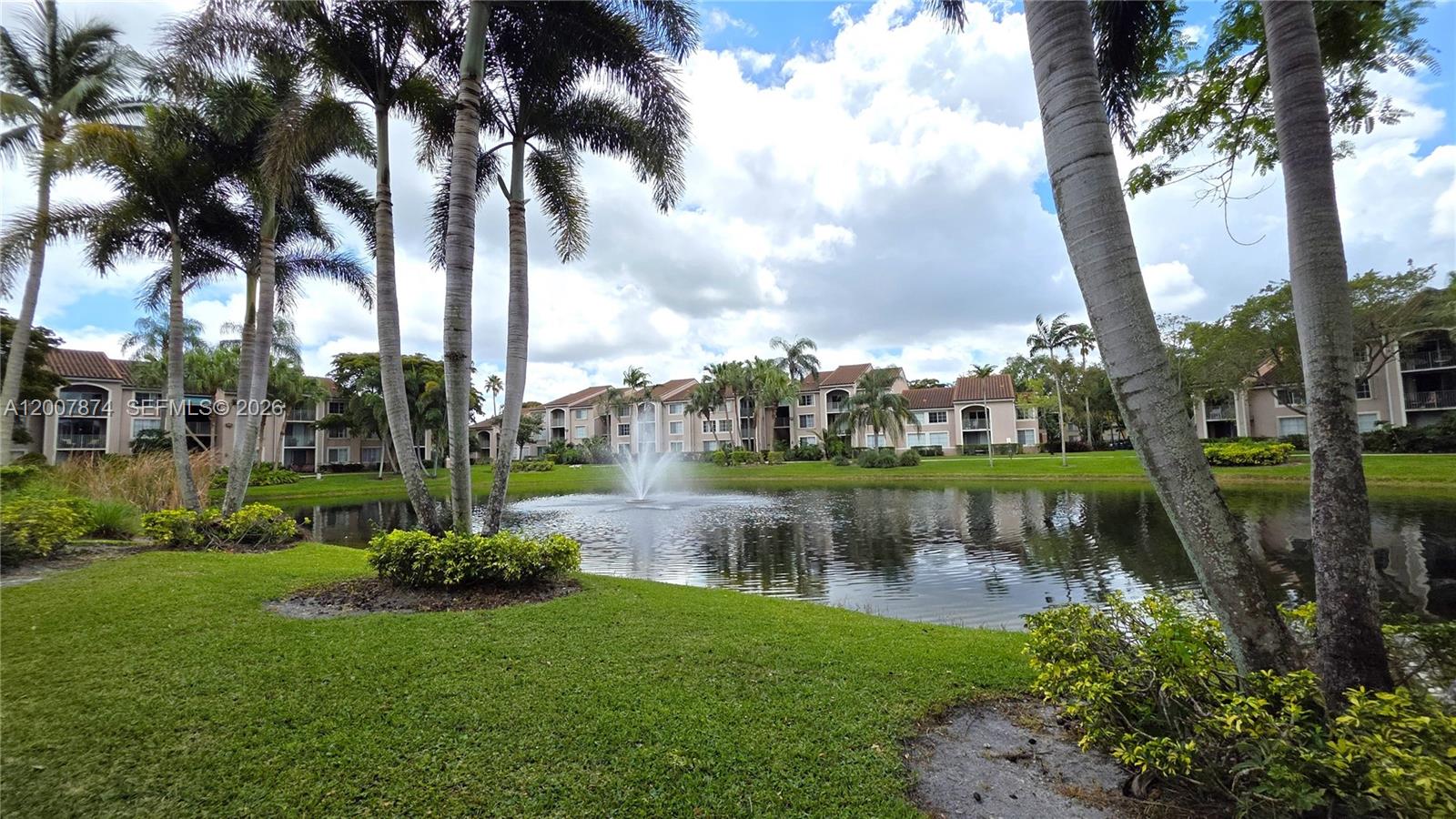 12136 St.Andrews Place, Unit 108 Miramar, FL 33025 - Photo 41 of 43 a view of a lake with a building in the background