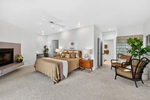 a spacious bedroom with a bed and a fireplace