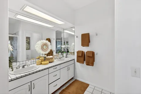 a bathroom with a sink mirror and vanity