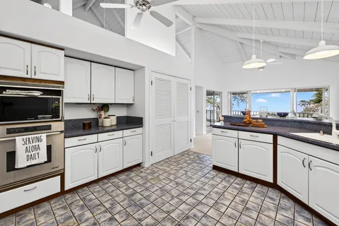 a kitchen with a sink cabinets and appliances