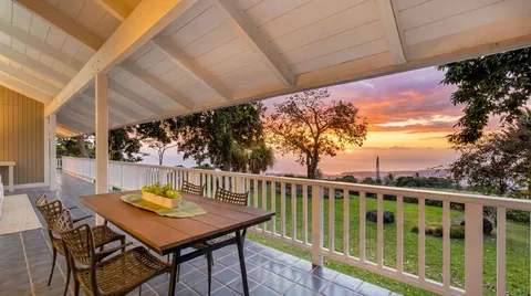 a view of a balcony with table and chairs